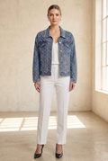 Embellished denim jacket styled with white trousers