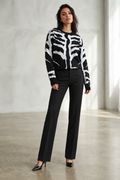 Model styled with elegant black trousers and pointed-toe pumps