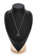 Necklace on its display stand with a plain white background