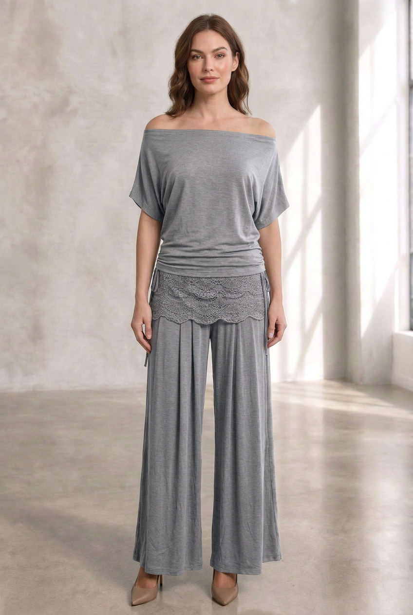Same model wearing the gray outfit in the sunlit studio