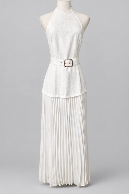 White belted halter outfit with a pleated skirt on a plain light-gray background